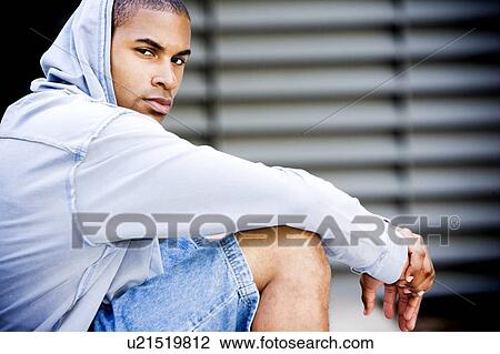 Portrait of a young African American man in a grey hooded top View Large Photo Image Stock Image - Portrait of a young African American man in a grey hooded top. Fotosearch