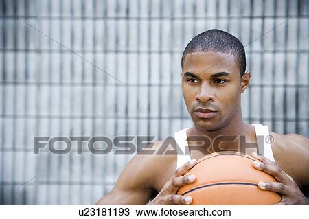 Portrait of a young African American man holding a basketball. View Large Photo Image Stock Image - Portrait of a young African American man holding a basketball. . Fotosearch
