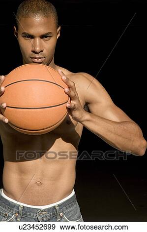 Portrait of a young African American man holding a basketball. View Large Photo Image Stock Photo - Portrait of a young African American man holding a basketball. . Fotosearch