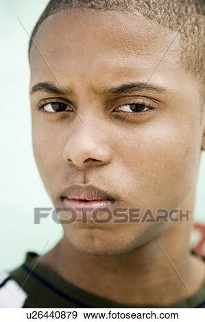 Portrait of a young African American man in front of a graffiti covered wall View Large Photo Image Stock Photo - Portrait of a young African American man in front of a graffiti covered wall. Fotosearch