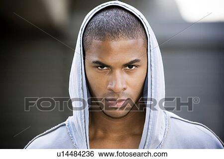 Stock Photograph - Portrait of a young African American man in a grey hooded top. Fotosearch