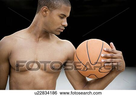 Portrait of a young African American man holding a basketball. View Large Photo Image Stock Photograph - Portrait of a young African American man holding a basketball. . Fotosearch