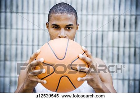 Portrait of a young African American man holding a basketball. View Large Photo Image Stock Photography - Portrait of a young African American man holding a basketball. . Fotosearch