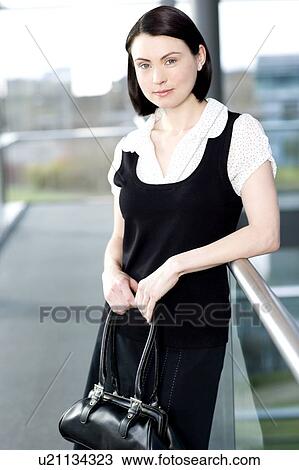 Stock Image - Portrait of a young businesswoman in an office building. Fotosearch