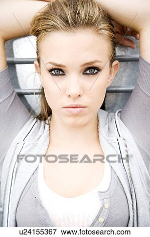 Portrait of a young girl leaning against a metallic wall View Large Photo Image Stock Photo - Portrait of a young girl leaning against a metallic wall . Fotosearch
