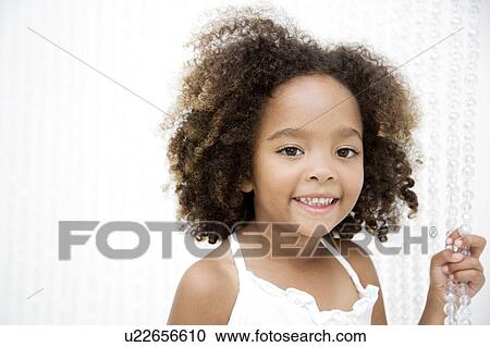 Stock Image - Portrait of a young girl, smiling. Fotosearch