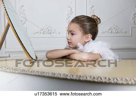 Stock Photography - Portrait of a young girl with a feather boa in dressing up clothes. Fotosearch