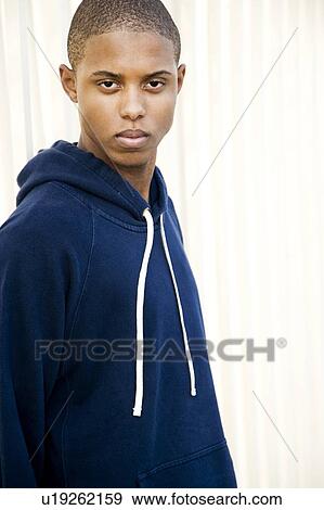 Stock Photo - Portrait of a young man behind bars. Fotosearch
