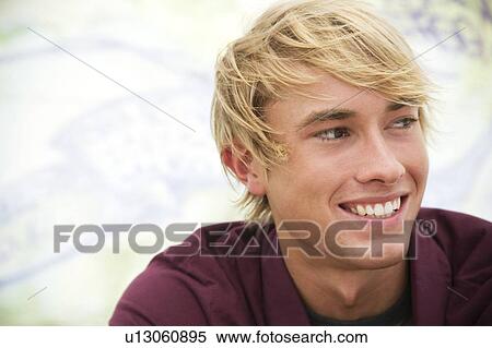 Portrait of a young man in front of a graffiti covered wall View Large Photo Image Stock Photography - Portrait of a young man in front of a graffiti covered wall. Fotosearch