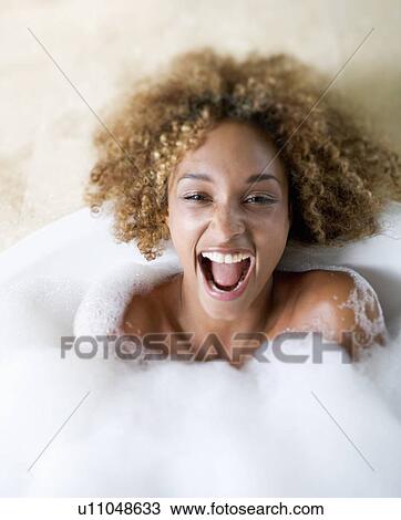 Stock Image - Portrait of a young woman in a bath. Fotosearch