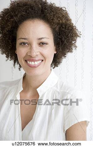 Stock Photograph - Portrait of a young woman, smiling. Fotosearch