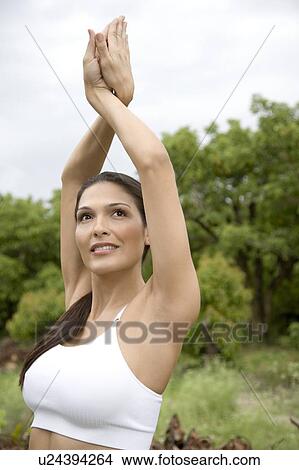 Picture - Portrait of an Hispanic woman practicing yoga woman outside. . Fotosearch