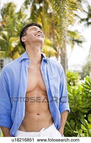 Portrait of man in tropical setting, shirt open View Large Photo Image Stock Image - Portrait of man in tropical setting, shirt open. Fotosearch