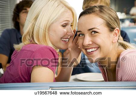 Stock Photo - Portrait of smiling teenage girls with her friends in a diner . Fotosearch