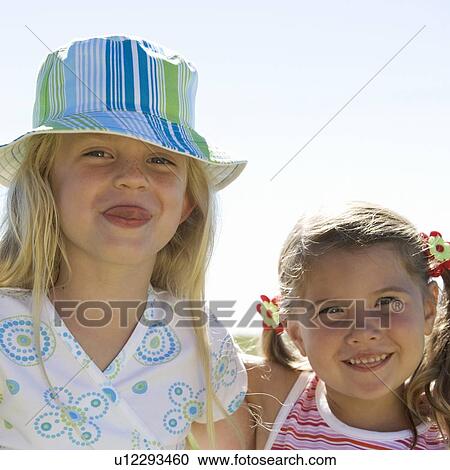 Stock Image - Portrait of two young girls. Fotosearch