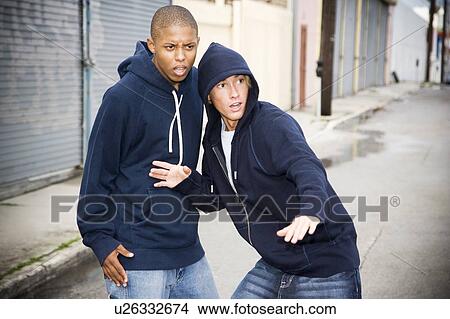 Portrait of two young street gang members looking suspicious View Large Photo Image Picture - Portrait of two young street gang members looking suspicious . Fotosearch
