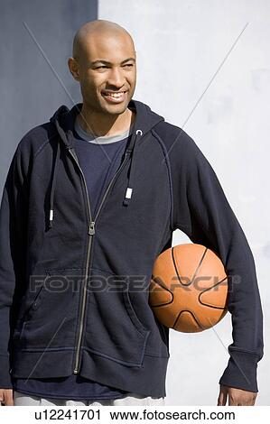 Portrait of young African American man holding a basketball View Large Photo Image Stock Image - Portrait of young African American man holding a basketball. Fotosearch