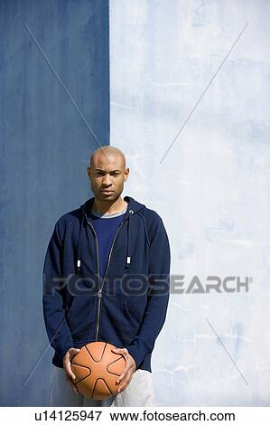 Portrait of young African American man holding a basketball View Large Photo Image Stock Photo - Portrait of young African American man holding a basketball. Fotosearch