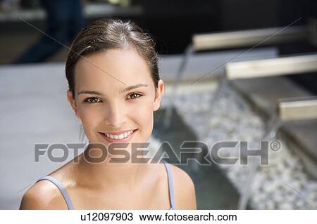 Stock Image - Portrait of young woman outside. Fotosearch