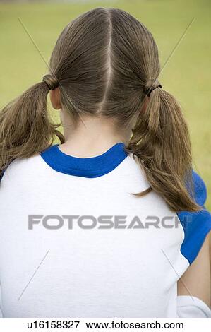 Rear view girl sitting on the grass View Large Photo Image Stock Photo - Rear view girl sitting on the grass. Fotosearch
