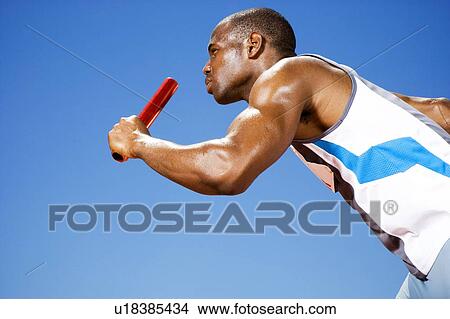 Relay runner with baton in his hand View Large Photo Image Picture - Relay runner with baton in his hand. Fotosearch
