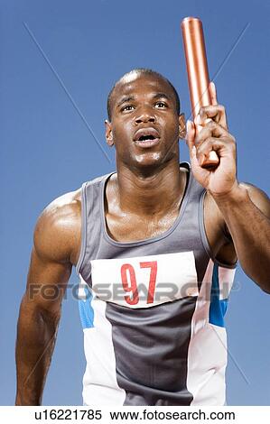 Stock Photography - Relay runner with baton in his hand. Fotosearch