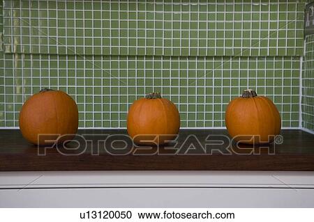 Row of orange Hallowe'en pumpkins on a kitchen counter View Large Photo Image Stock Image - Row of orange Hallowe'en pumpkins on a kitchen counter. Fotosearch