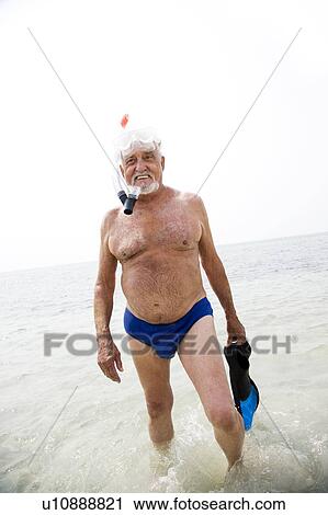 Senior man with snorkel gear at the beach View Large Photo Image Stock Image - Senior man with snorkel gear at the beach . Fotosearch