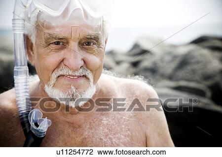 Senior man with snorkel gear at the beach View Large Photo Image Stock Image - Senior man with snorkel gear at the beach . Fotosearch
