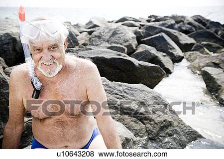 Senior man with snorkel gear at the beach View Large Photo Image Stock Photo - Senior man with snorkel gear at the beach . Fotosearch