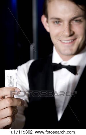Stock Image - Smartly dressed usher at the cinema or theatre. Fotosearch