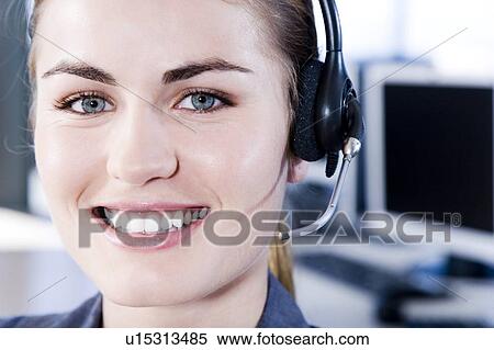 Smiling businesswoman in a call centre View Large Photo Image Stock Photography - Smiling businesswoman in a call centre. Fotosearch