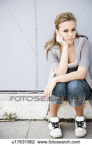 Teenage girl sat with her head on her hand View Large Photo Image Stock Image - Teenage girl sat with her head on her hand . Fotosearch