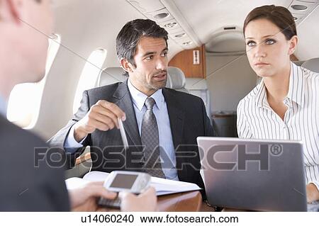 Stock Image - Three business colleagues working on a flight. Fotosearch