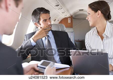 Three business colleagues working on a flight View Large Photo Image Stock Image - Three business colleagues working on a flight. Fotosearch