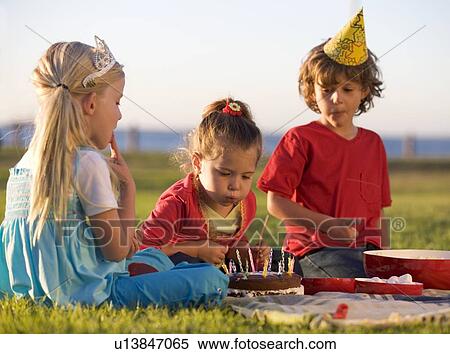 Three children on a birthday picnic View Large Photo Image Stock Photography - Three children on a birthday picnic. Fotosearch