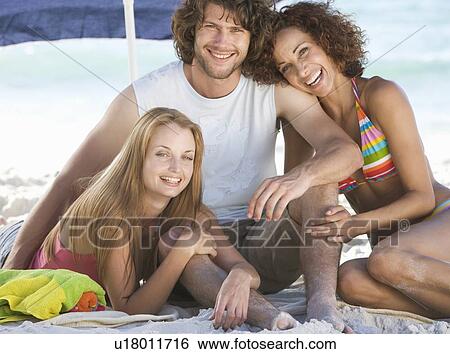 Three friends on a beach View Large Photo Image Stock Photograph - Three friends on a beach. Fotosearch