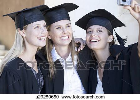 Stock Image - Three graduates celebrating. Fotosearch