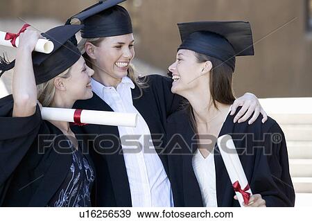 Three graduates celebrating View Large Photo Image Stock Photo - Three graduates celebrating. Fotosearch