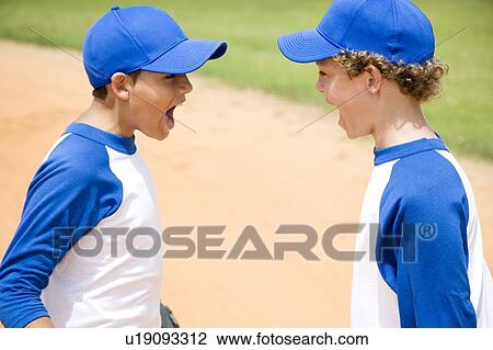 Stock Image - two boys in baseball gear shouting at each other. Fotosearch