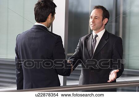 Picture - Two businessmen shaking hands. Fotosearch