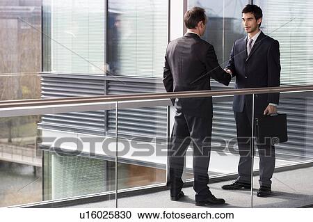 Two businessmen shaking hands View Large Photo Image Stock Image - Two businessmen shaking hands. Fotosearch