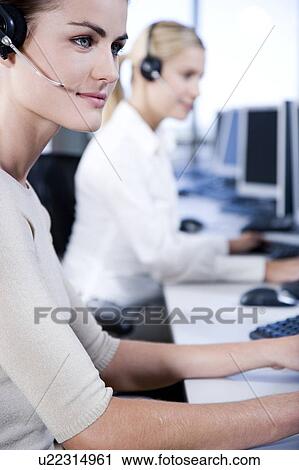 Two businesswomen in a call centre View Large Photo Image Stock Image - Two businesswomen in a call centre. Fotosearch