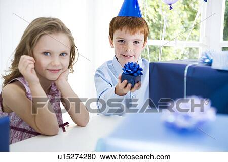 Stock Image - two children at a birthday party. Fotosearch