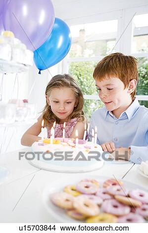 two children sitting at birthday tea table View Large Photo Image Picture - two children sitting at birthday tea table. Fotosearch