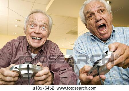 Two elderly men playing a video game View Large Photo Image Stock Image - Two elderly men playing a video game. Fotosearch