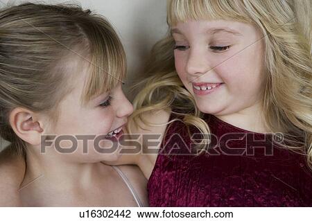 Stock Image - Two friends in party dresses . Fotosearch