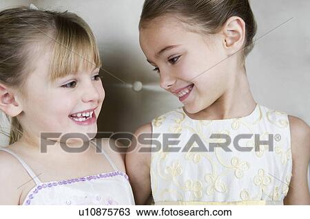 Two little girls wearing party dresses View Large Photo Image Stock Image - Two little girls wearing party dresses. Fotosearch