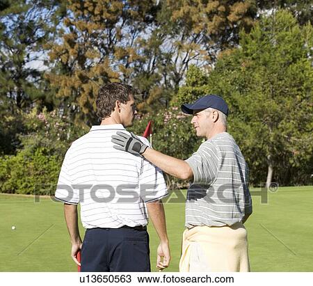 Two men playing golf View Large Photo Image Stock Image - Two men playing golf. Fotosearch