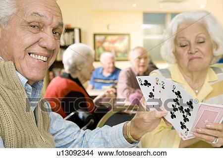 Picture - Two residents in a retirement home playing cards. Fotosearch